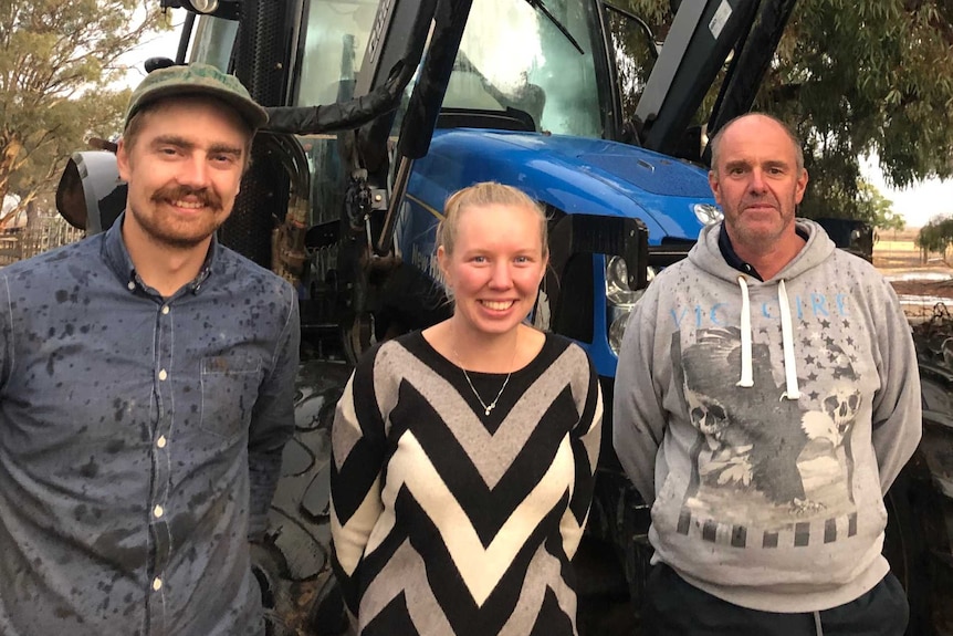 Alfie Jessop, Jess Mumford and dairy farmer Steve Dalitz standing in front of a tractor on a farm in northern Victoria.