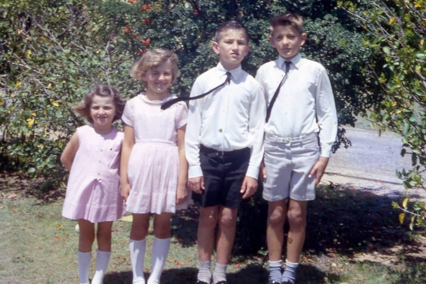 Old photo of two girls, two boys in good clothes