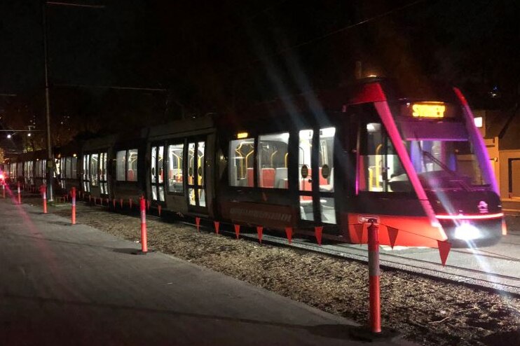 A tram travels on brand new tracks at night
