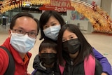 Xiaoning Mo and her family pictured at Baiyun airport wearing facemasks.