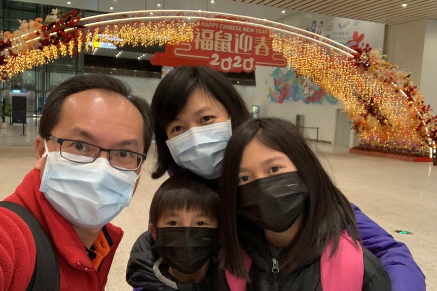 Xiaoning Mo and her family pictured at Baiyun airport wearing facemasks.