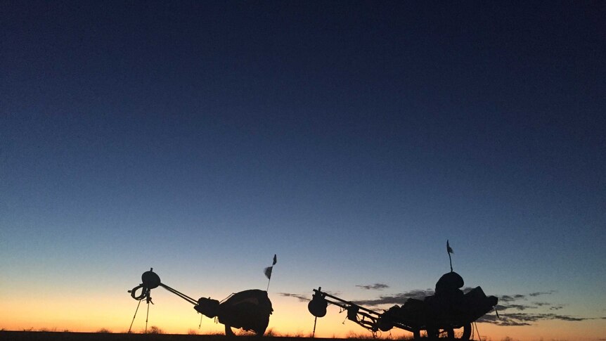 A sunset creates a silhouette of the buddy used to cross the Outback.