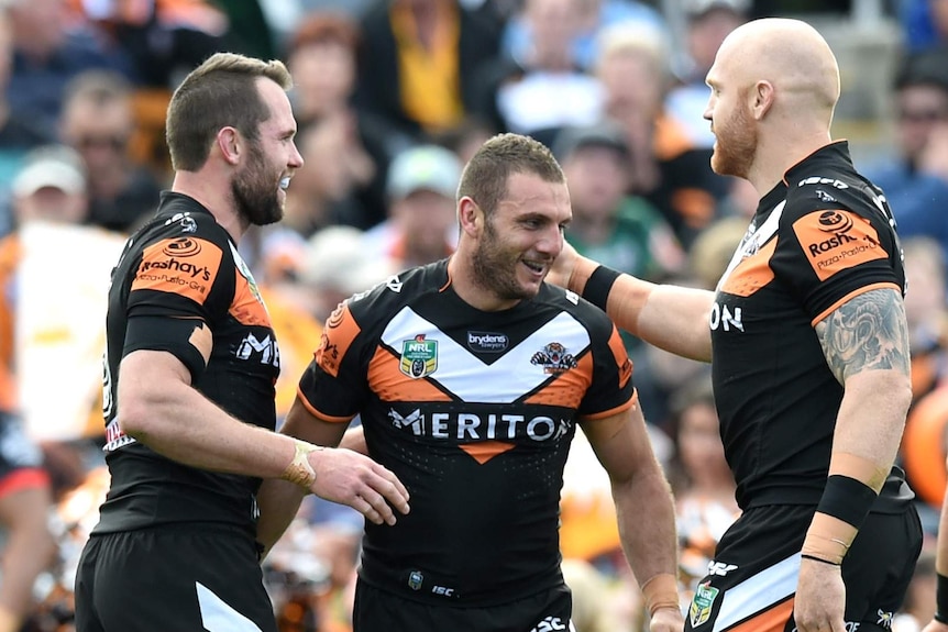 Pat Richards, Robbie Farah and Keith Galloway celebrate a try against the Warriors