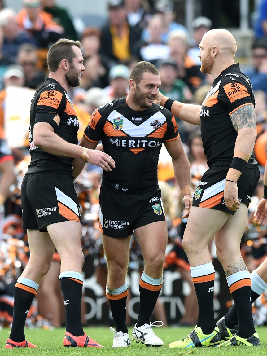 Pat Richards, Robbie Farah and Keith Galloway celebrate a try against the Warriors