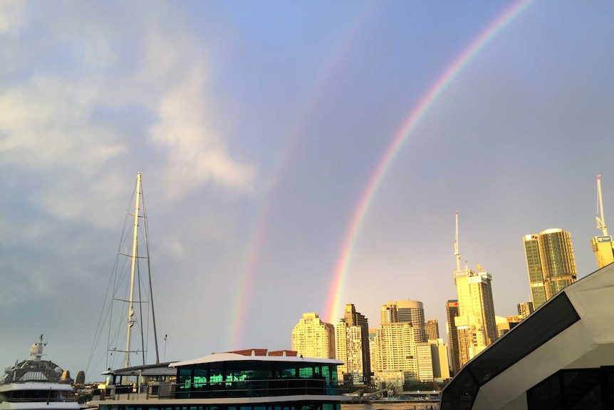 A photo taken on Sydney's waterfront shows a double rainbow over the city.