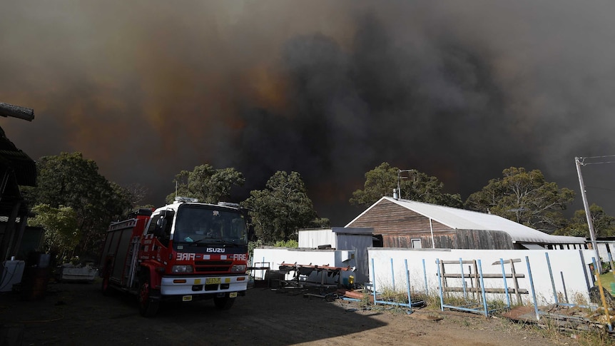 The roof of a house, surrounded by thick black smoke.