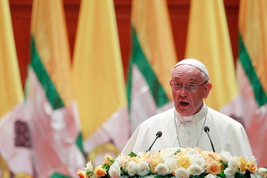 Pope Francis standing at podium