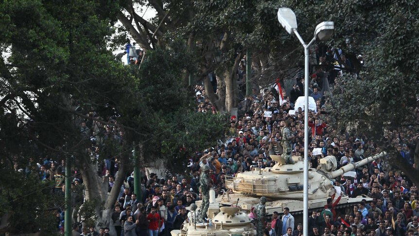 Demonstrators surround tanks on Cairo streets