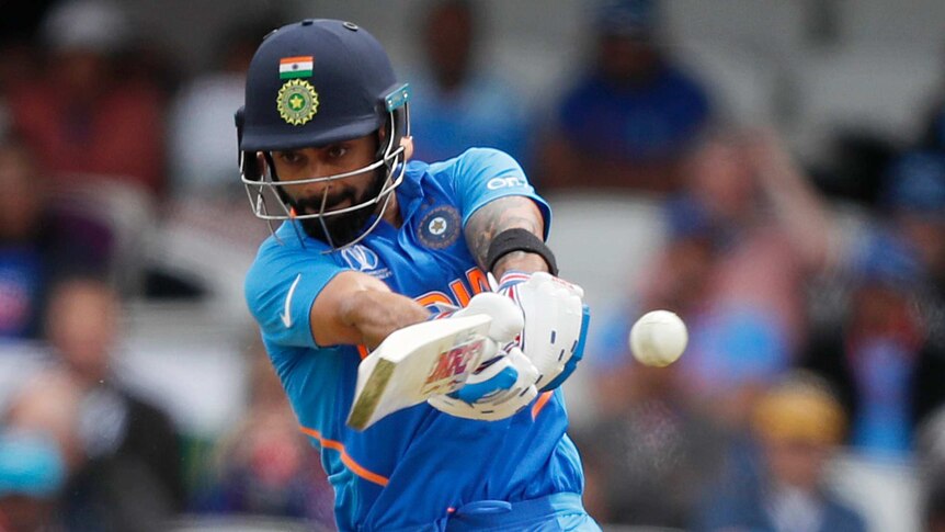An Indian batsman plays a cross-bat shot on the on-side at the World Cup.