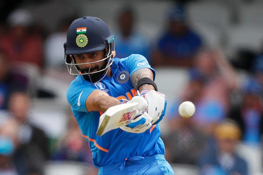An Indian batsman plays a cross-bat shot on the on-side at the World Cup.
