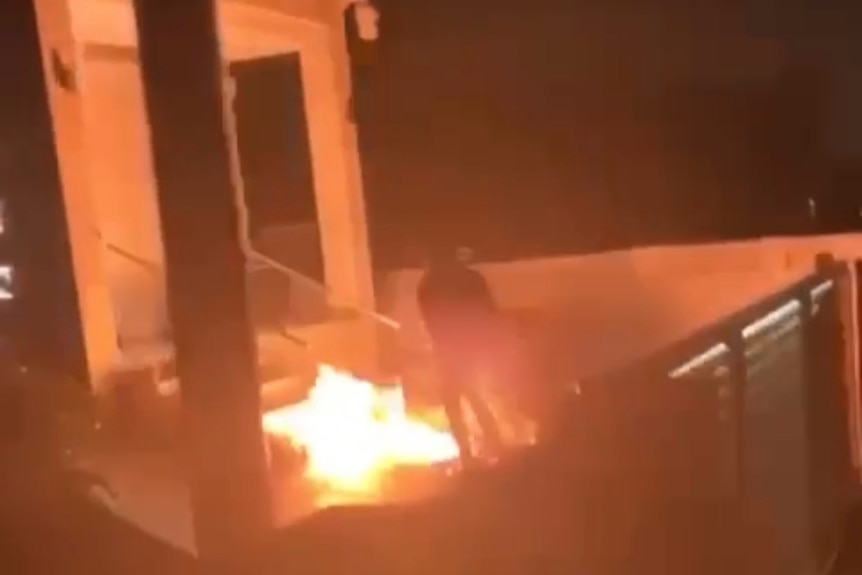 A fire on steps leading up to a house.