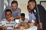Australian doctor Joshua Francis assists Timor-Leste health workers.