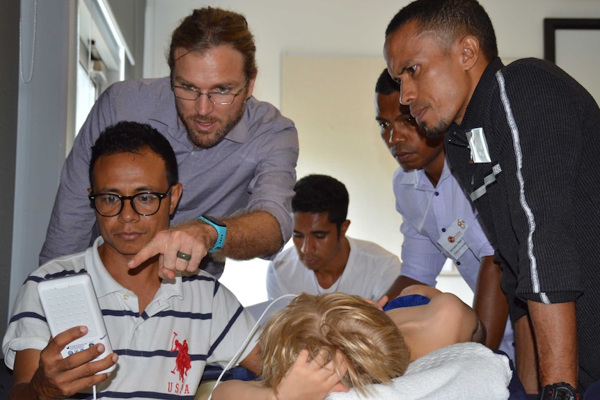 Australian doctor Joshua Francis assists Timor Leste health workers.