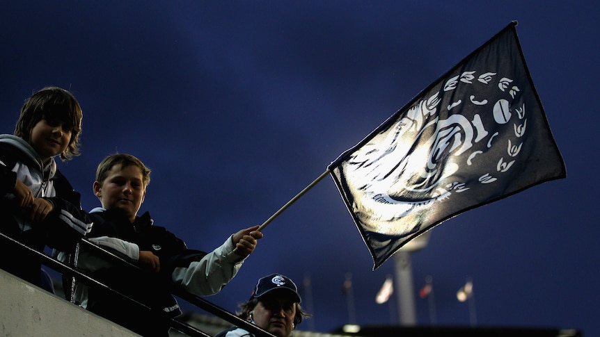 A Carlton supporter waves his flag at the MCG.