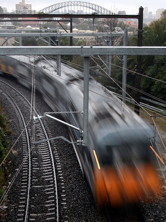 A commuter train travels through a suburb in inner Sydney. (Reuters: Tim Wimborne, file photo)