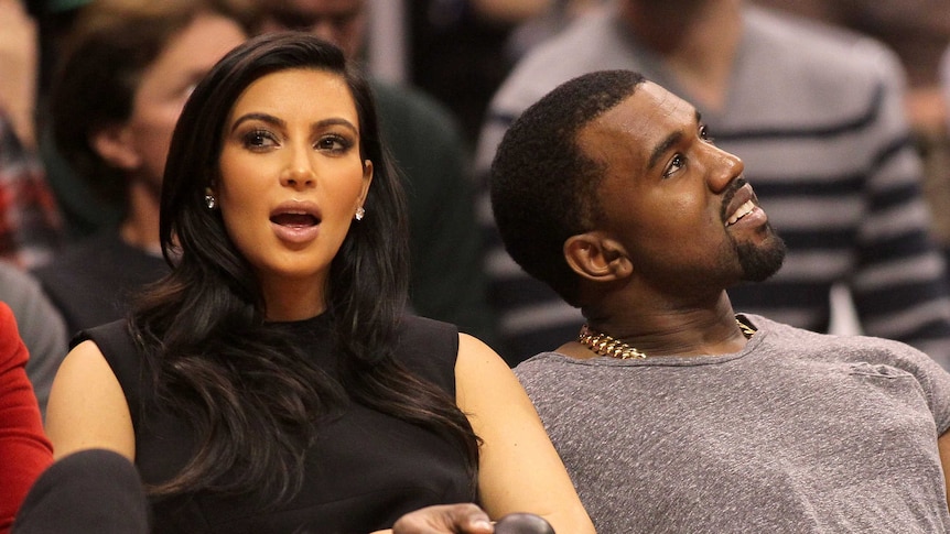 Kim Kardashian and Kanye West attend a basketball game in Los Angeles.