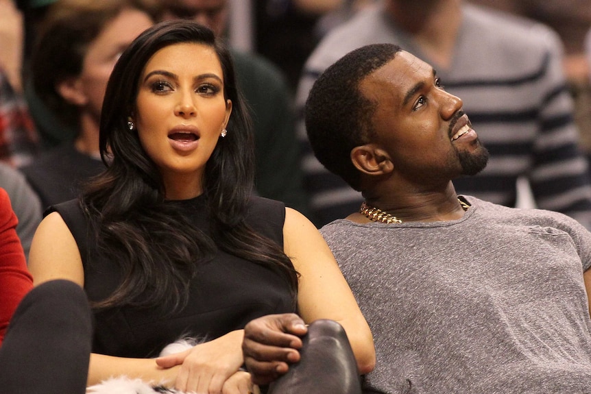 Kim Kardashian and Kanye West attend a basketball game in Los Angeles.