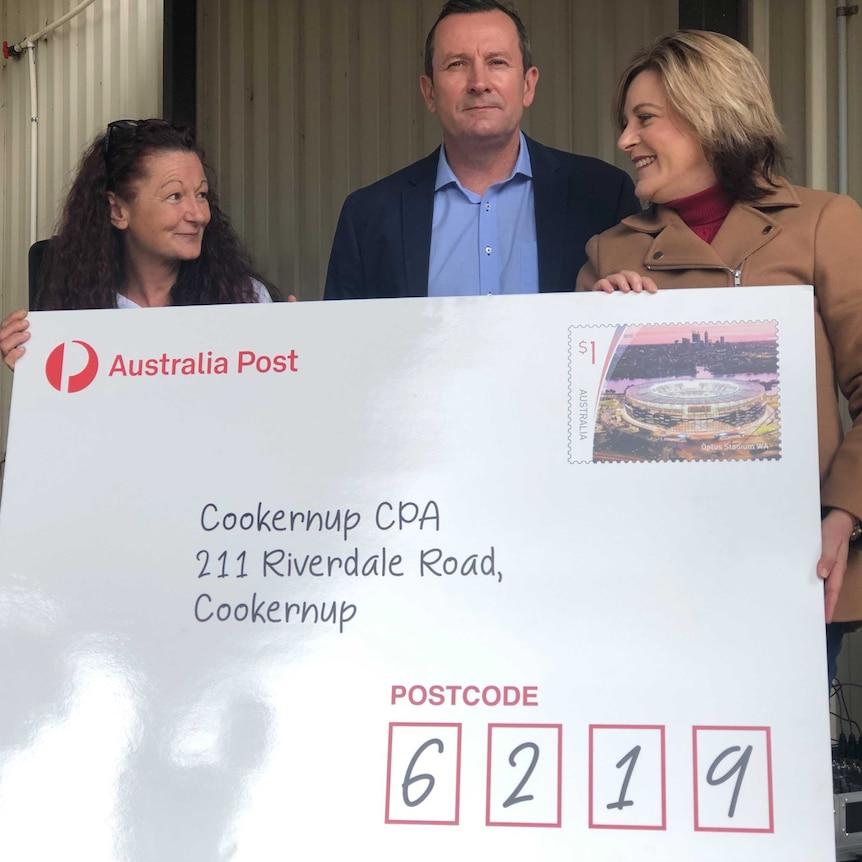 Two women and a man hold a giant envelope with a Cookernup address.