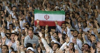 Tehran University students hold up Iranian flag