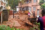 Mud and water cascades near houses in Freetown