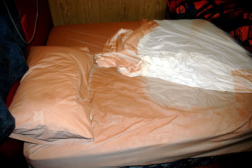 White bed sheets are covered in a thick film of red dust, after a dust storm in Queensland's south west.