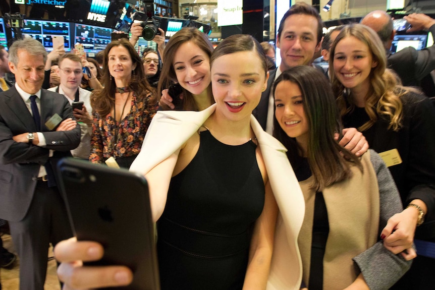 Miranda Kerr takes a selfie with friends at the opening bell at the New York Stock Exchange