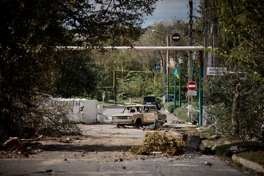 A damaged car with a letter 'Z' in seen in the town of Kupiansk.