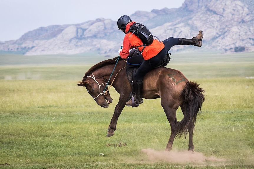 Rider Anthony Strange tries to hold onto a bucking horse during the Mongol Derby.