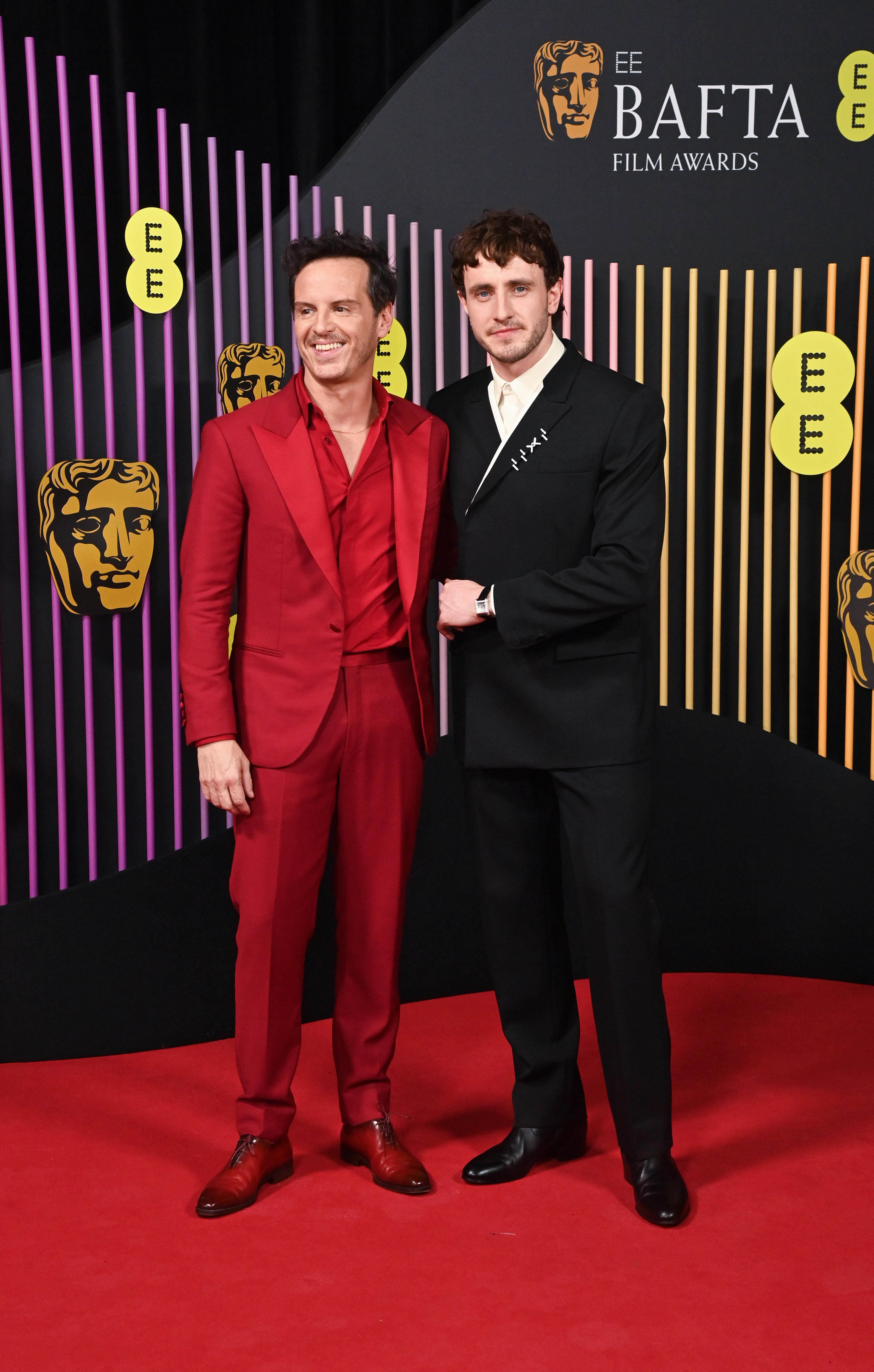 Andrew Scott and Paul Mescal on the red carpet in a red suit and a black suit