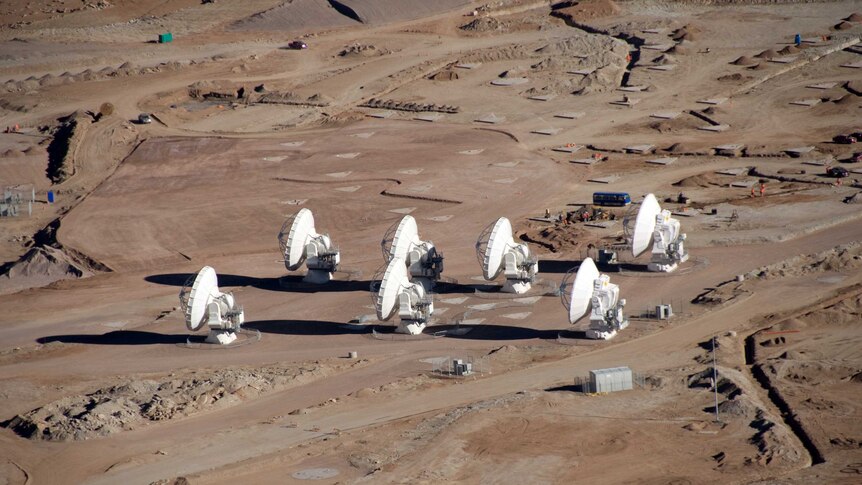 An aerial photo of seven telescopes.