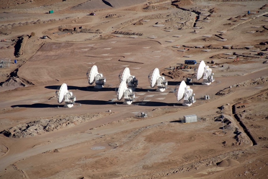 An aerial photo of seven telescopes.