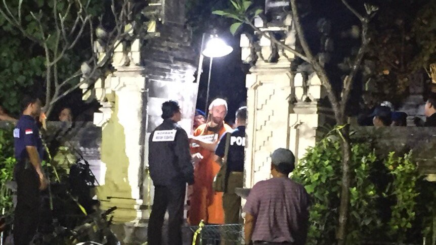 David Taylor with Bali police officers during a crime scene reconstruction on Kuta beach, media and other police look on.