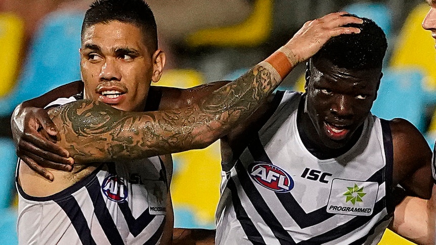 A close-up shot of Fremantle Dockers players Michael Walters and Michael Frederick celebrating after a goal.