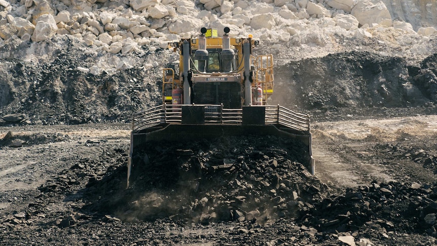 A large machine scoops up coal at Griffin Coal Mine in Collie WA.