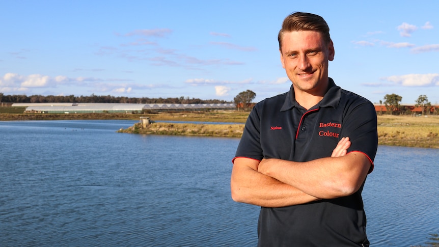 Applethorpe fruit grower Nathan Baronia standing next to an irrigation dam on his property, September 2020.