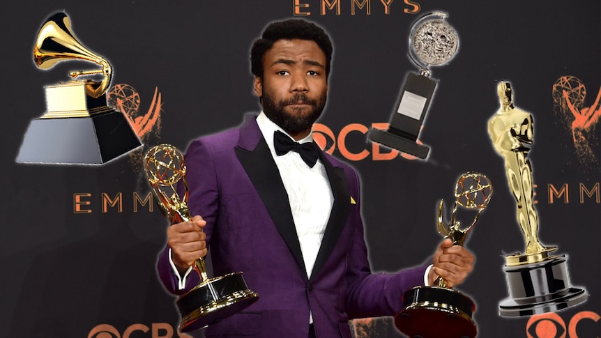 Donald Glover holding his Emmys surrounded by floating Grammy, Tony and Academy awards