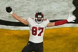 Rob Gronkowski puts his arms out to celebrate a Tampa Bay Buccaneers touchdown on the Kansas City Chiefs logo.
