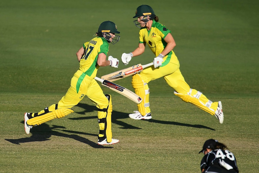 Meg Lanning (left) and Annabel Sutherland (right) run between wickets for the Australian women's cricket team.
