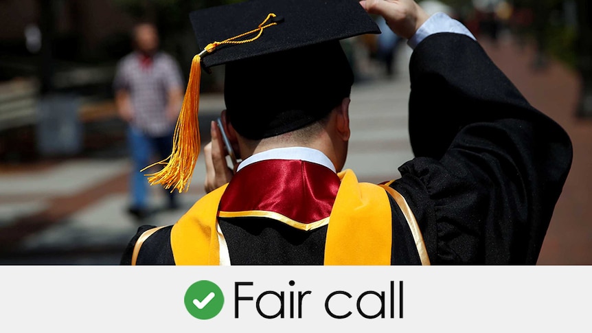 A university graduate with mortarboard from behind. Verdict: fair call with a green tick
