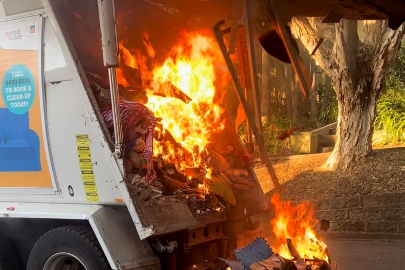 A garbage truck with fire.
