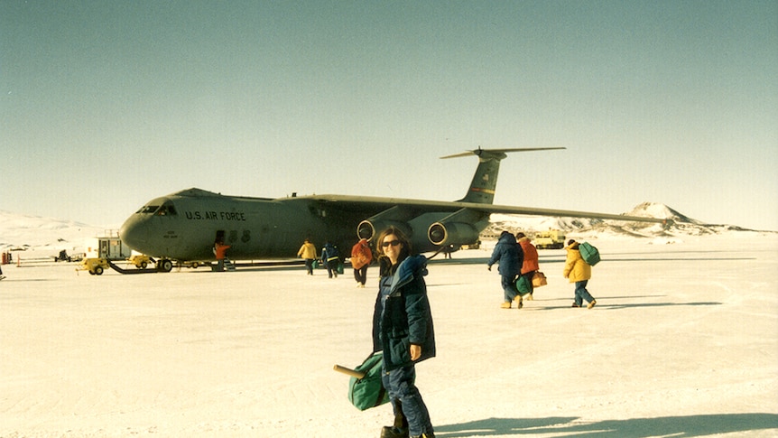 Nicole Webster out the front of a military plane in Antarctica.