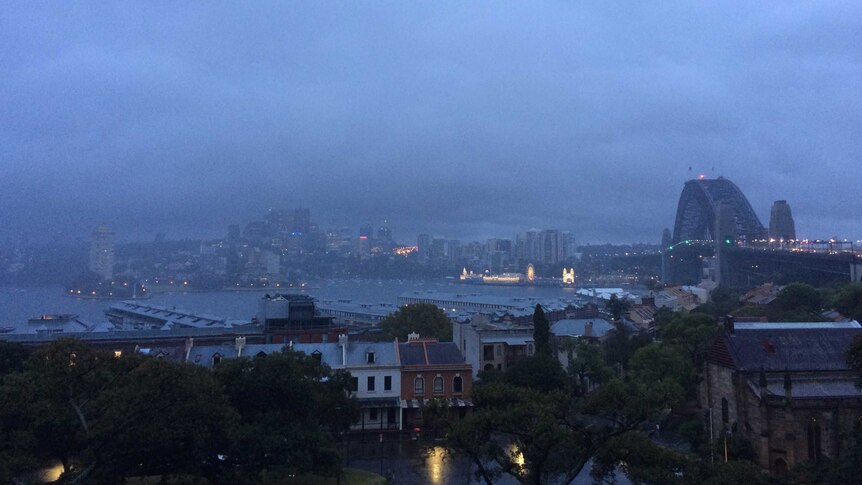 The view of Sydney Harbour, the Harbour Bridge and North Sydney in early morning light.