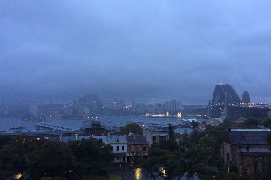 The view of Sydney Harbour, the Harbour Bridge and North Sydney in early morning light.