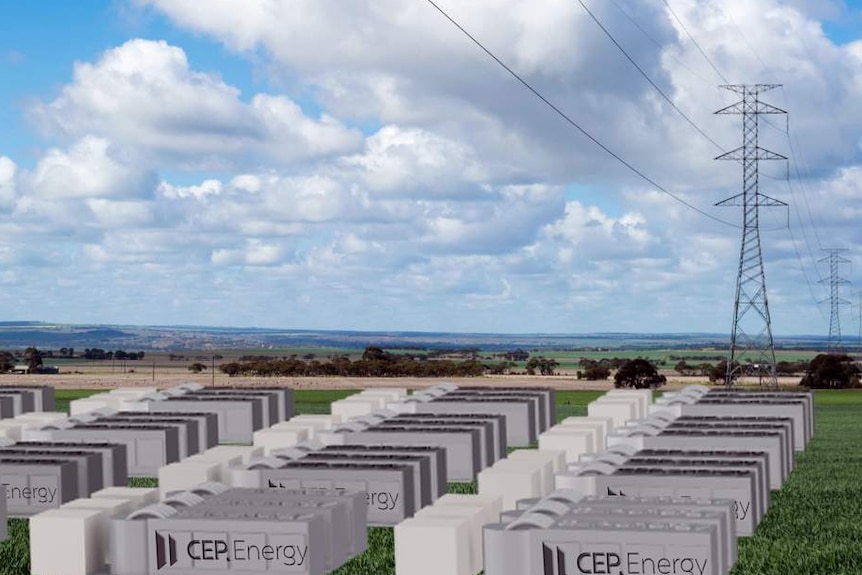 A mock-up of several large batteries in a field, near a large power transmission tower.