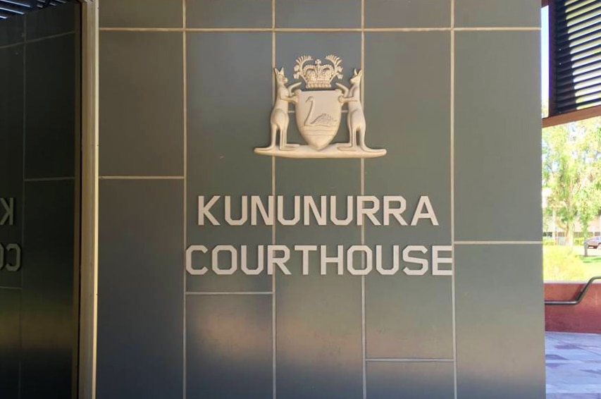 A close-up shot of a Kununurra Courthouse sign on the outside of the building.