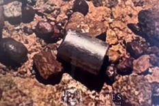 A small capsule nestled in rocks.