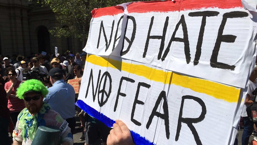 Protesters hold up a "no hate, no fear" banner in Bendigo.