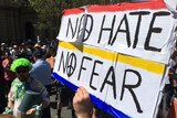 Protesters hold up a "no hate, no fear" banner in Bendigo.