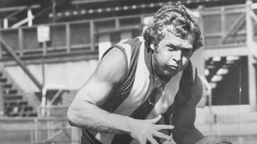 A black and white photo of Barry Cable in action on the field