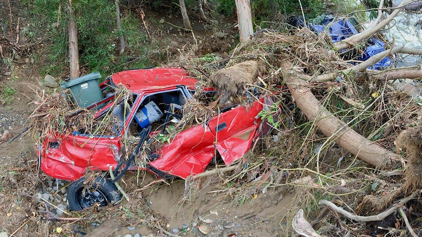 Wrecked cars in the New Town rivulet, following the flood of May 11, 2018